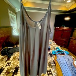 Pleated tanks.  Size large will fit up to 2x. Very loose fitting  multi colors
